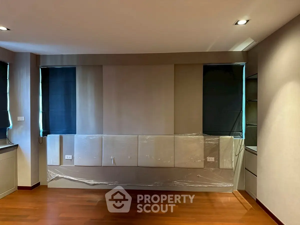 Spacious modern living room with hardwood floors and elegant wall paneling