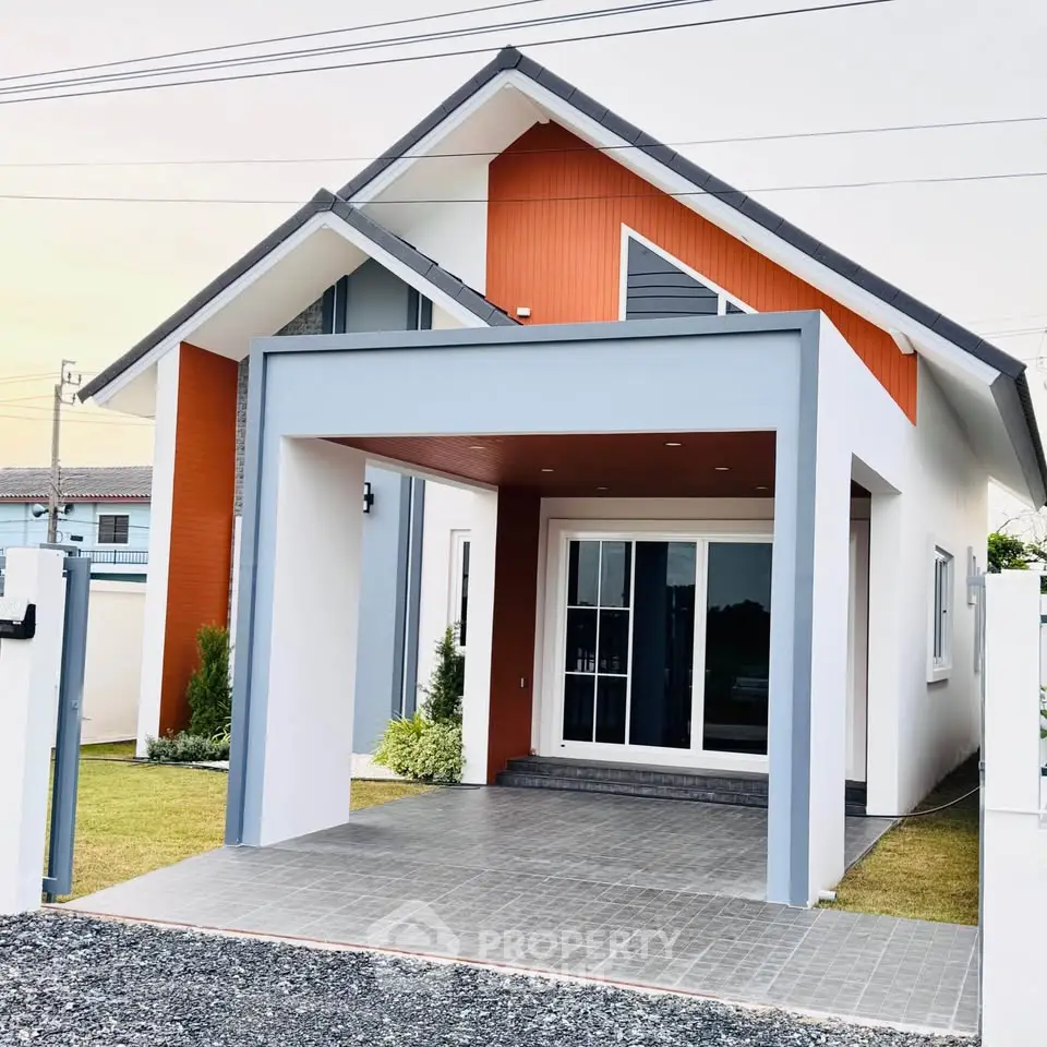 Modern single-story house with unique architectural design and spacious driveway.