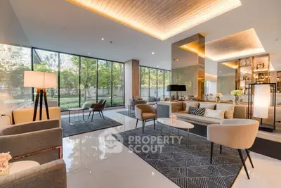 Luxurious modern living room with elegant decor and large windows offering garden views.