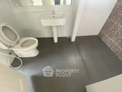 Modern bathroom with sleek design and tiled flooring