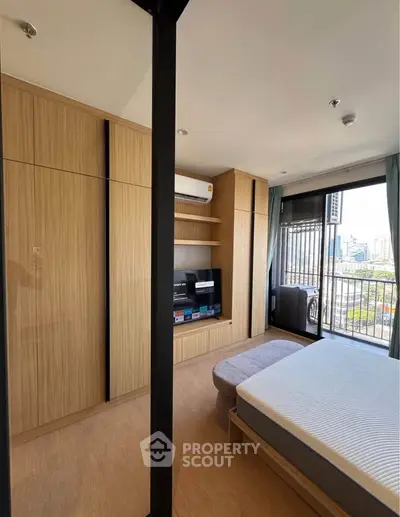 Modern bedroom with city view, featuring built-in wooden wardrobe and sleek design.