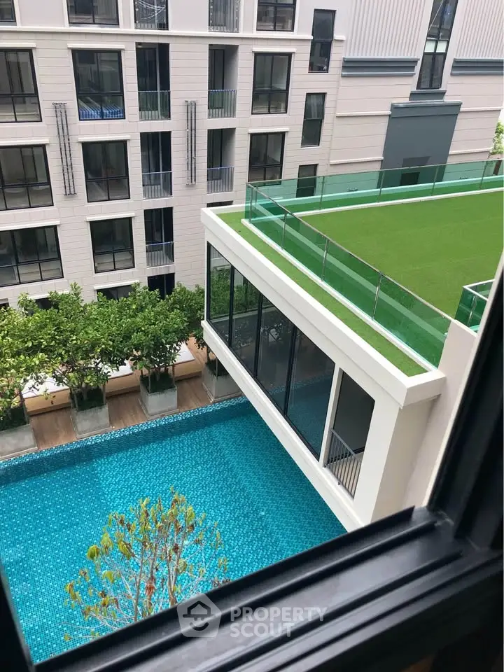 Modern apartment building with rooftop garden and pool view