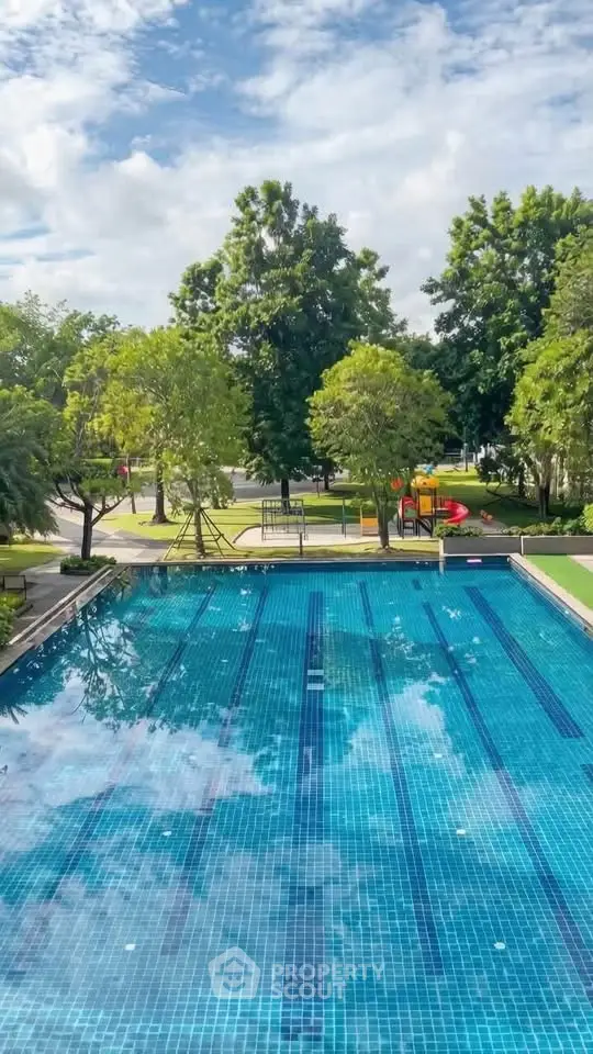 Luxurious outdoor pool with lush greenery and serene surroundings in a premium real estate property.
