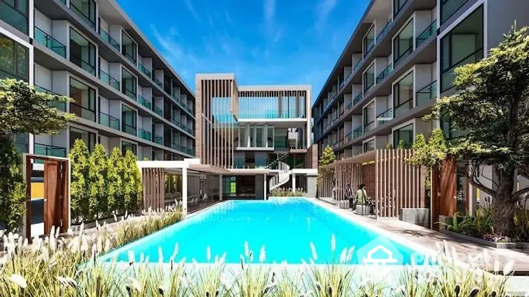 Luxurious residential complex with a large central swimming pool surrounded by modern apartments and lush greenery, offering a serene urban oasis.