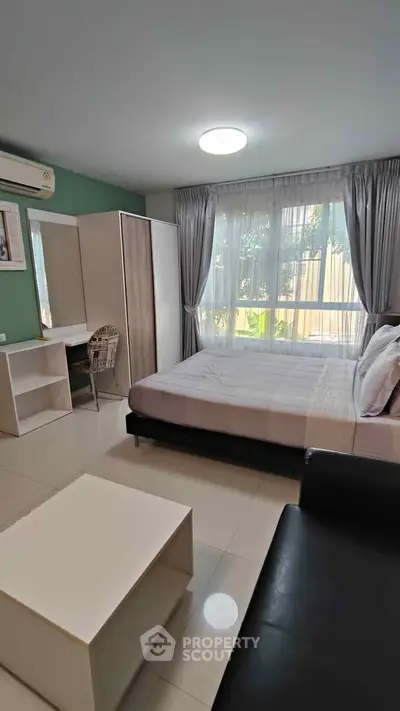 Modern bedroom with large window and stylish decor