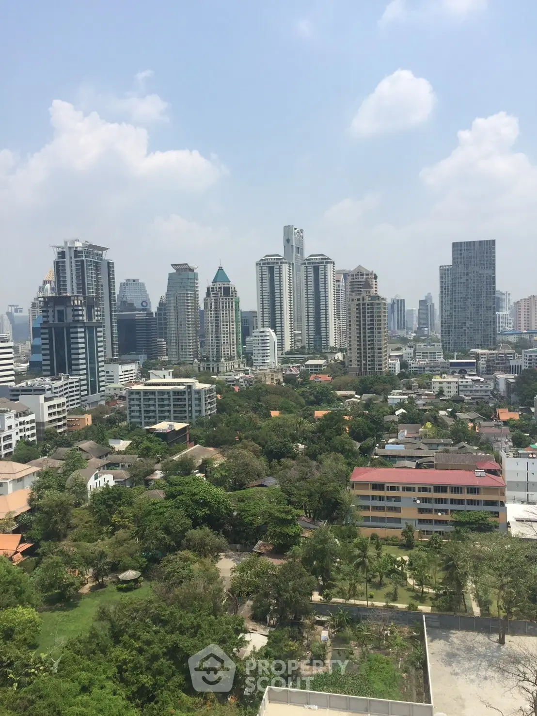 Stunning cityscape view with modern skyscrapers and lush greenery, perfect for urban living enthusiasts.