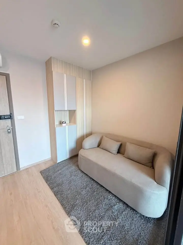 Modern living room with cozy sofa and stylish decor in a contemporary apartment.