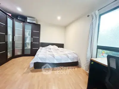 Spacious bedroom with large wardrobe and natural light