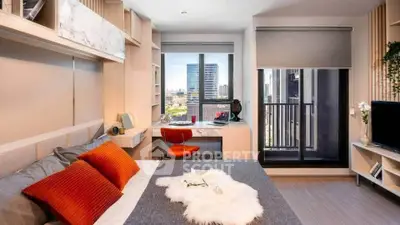 Modern bedroom with city view, stylish decor, and cozy workspace.