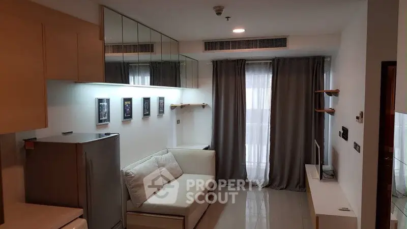 Modern living room with sleek design, featuring a cozy sofa, wall-mounted TV, and stylish decor.