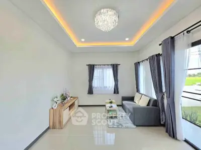 Spacious modern living room with elegant chandelier and natural light