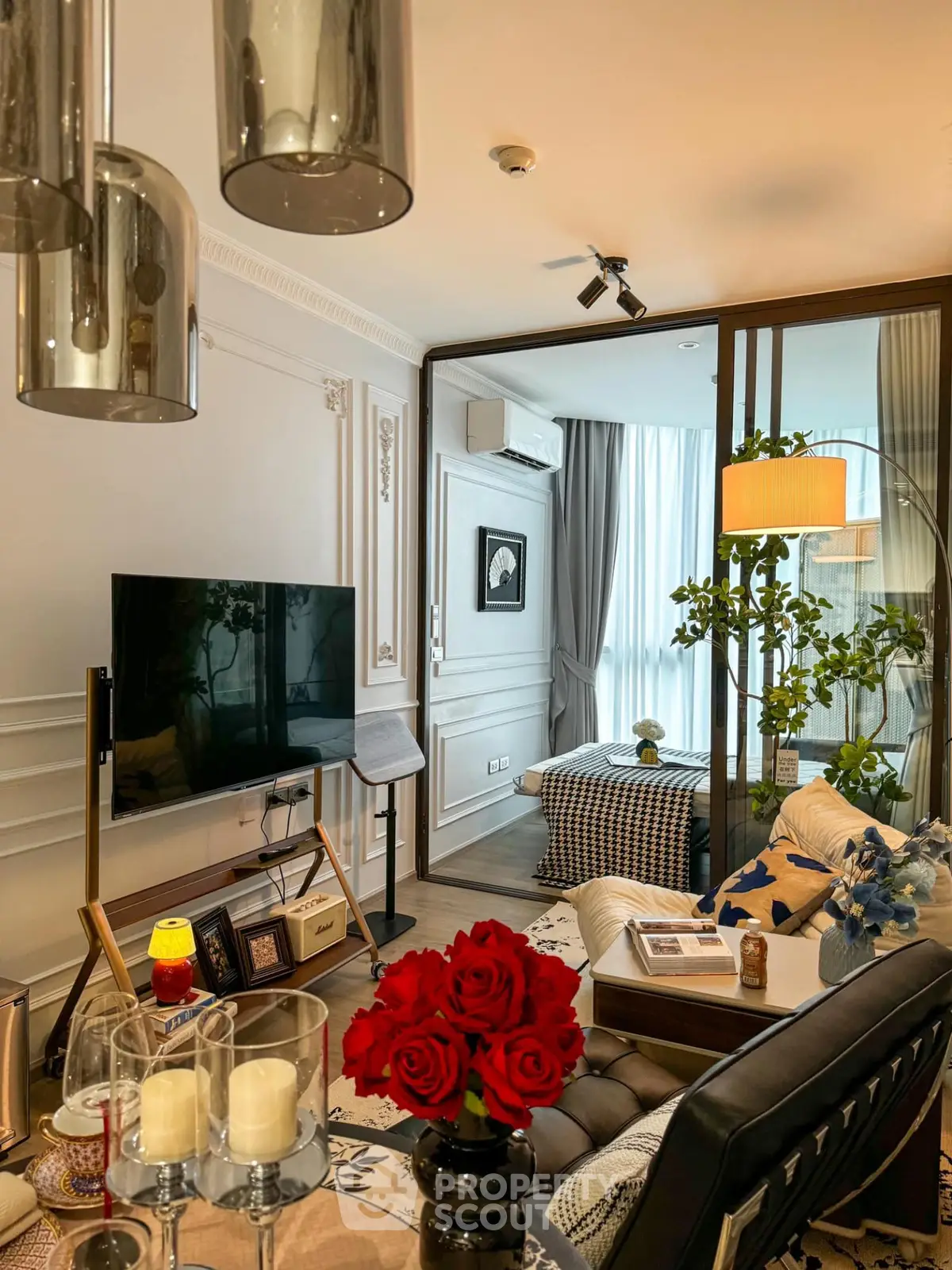 Luxurious living room with elegant decor, featuring a modern TV setup and stylish furniture, perfect for relaxation.