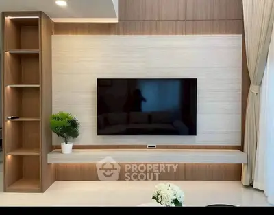 Modern living room with sleek TV setup and elegant shelving