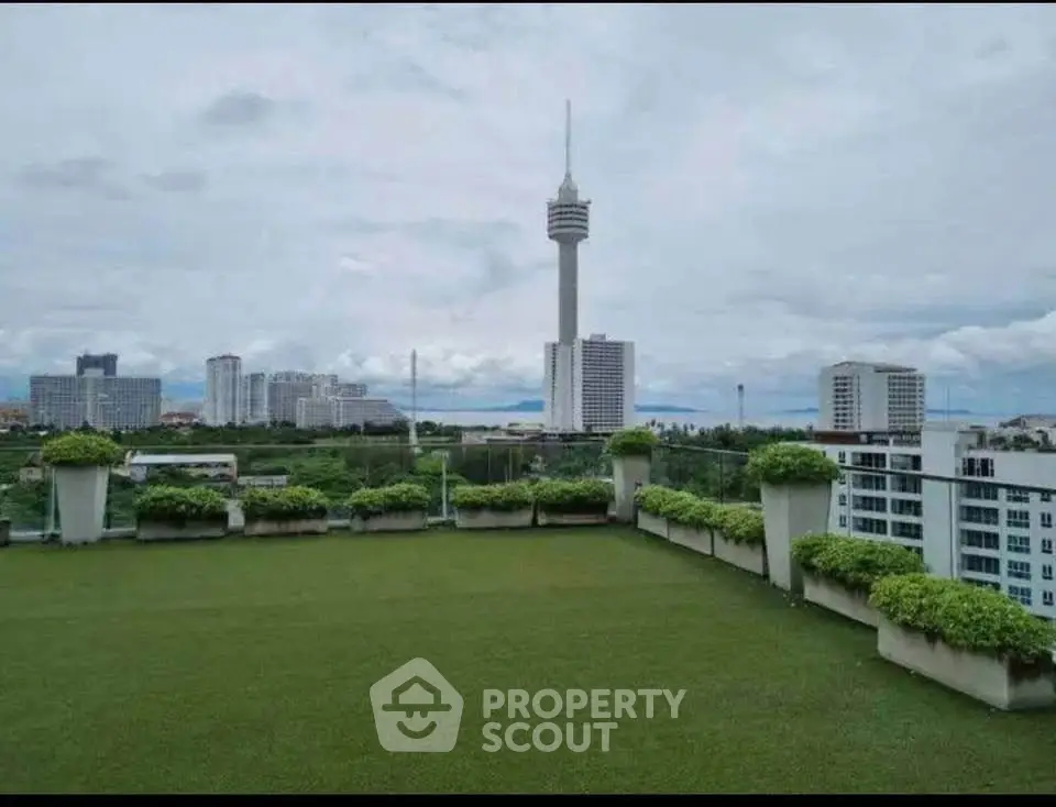 Stunning rooftop garden with panoramic city views and lush greenery.