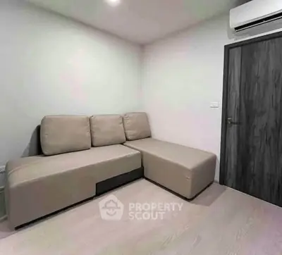 Modern minimalist living room with sleek sofa and air conditioning