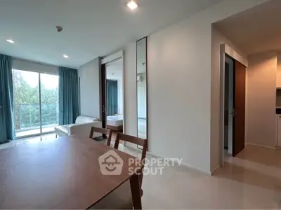 Modern apartment interior with dining area and balcony view