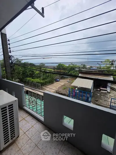 Charming balcony view with lush greenery and distant horizon, perfect for serene mornings.