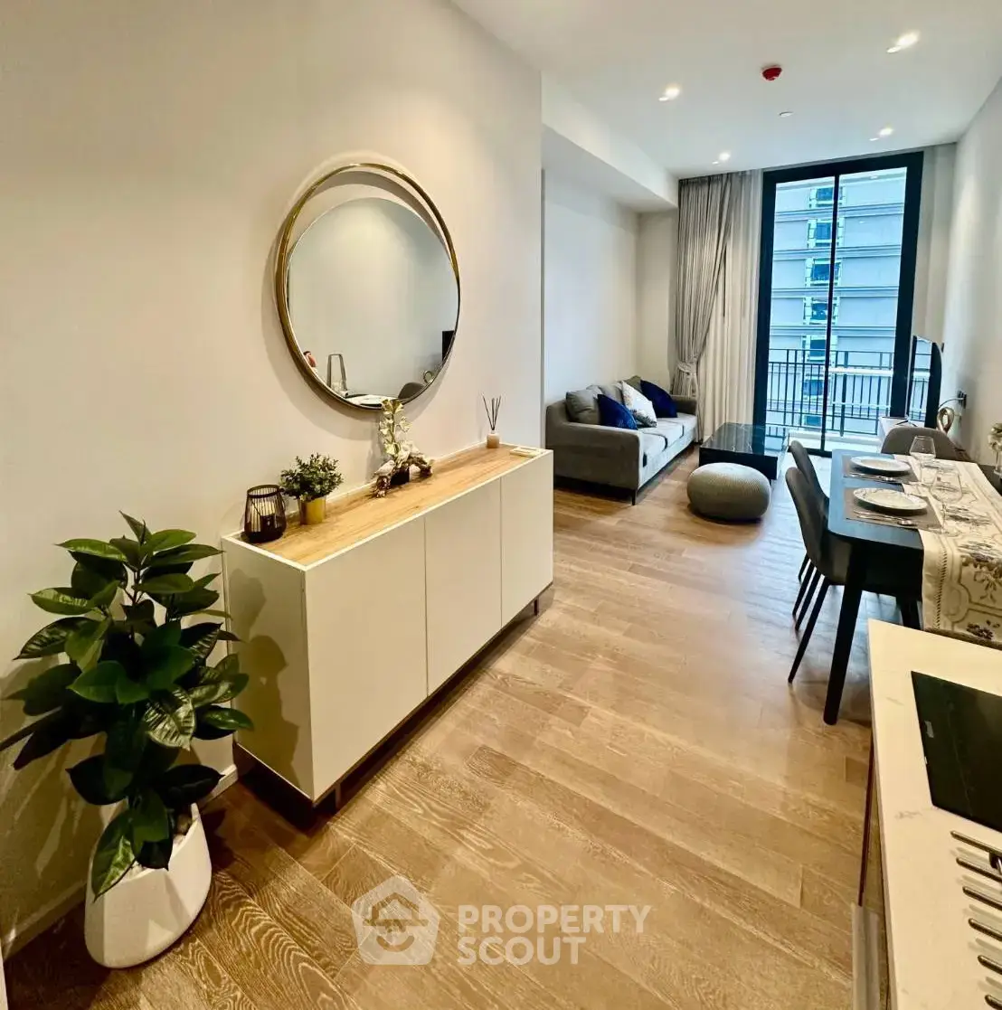 Modern living room with stylish decor and balcony view in a luxury apartment.