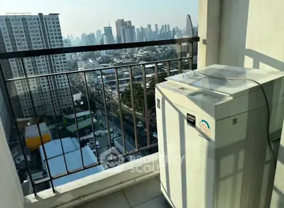 High-rise balcony with city view and washing machine, perfect urban living space.