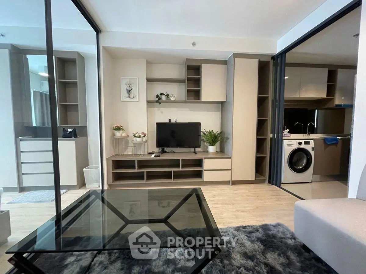 Modern living room with sleek furniture and open kitchen view