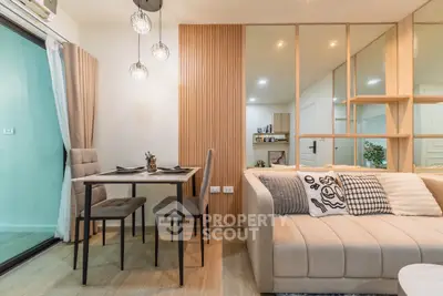 Modern living room with stylish decor and dining area in a cozy apartment.