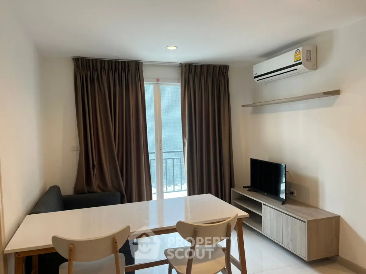 Modern living room with sleek furniture and balcony access in a stylish apartment.