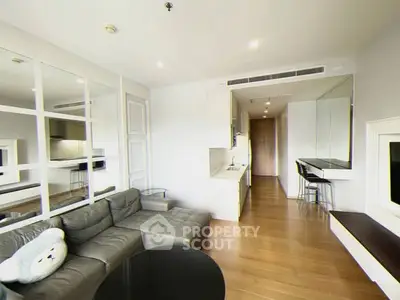 Modern living room with sleek kitchen and stylish decor