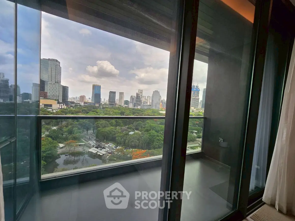 Stunning city view from a modern balcony overlooking lush greenery and skyline.