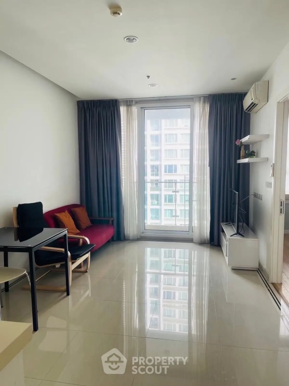 Modern living room with balcony view in high-rise apartment