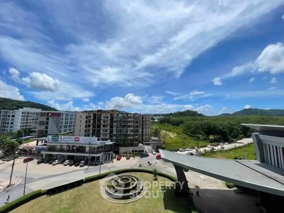 Stunning panoramic view of modern residential complex with lush greenery and blue skies.