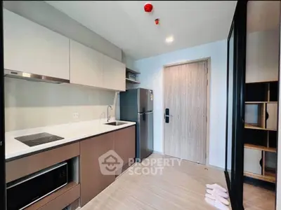 Modern kitchen with sleek cabinetry and appliances in a stylish apartment.