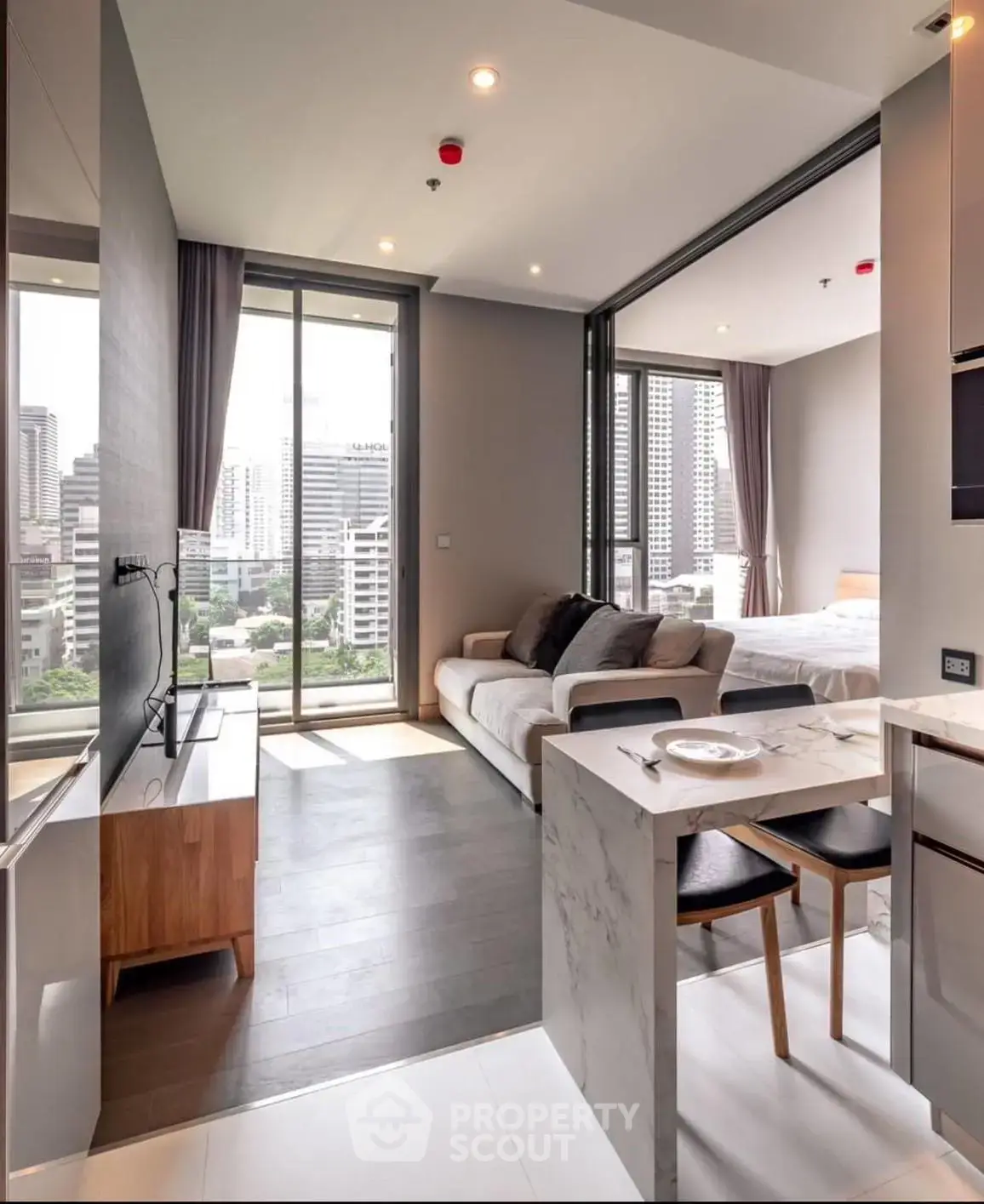 Modern open-plan living room with city view and stylish decor