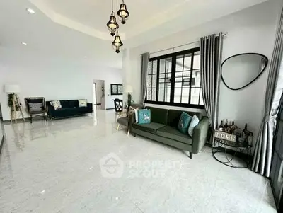 Spacious modern living room with elegant decor and large windows.