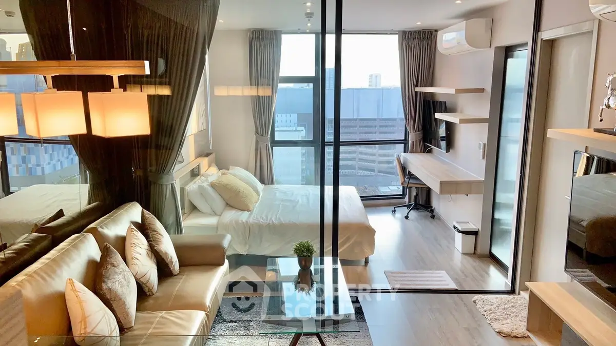 Modern studio apartment with glass partition, cozy living area, and city view.