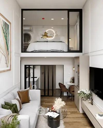 Modern loft apartment with stylish decor, featuring a cozy living area and elevated bedroom space.