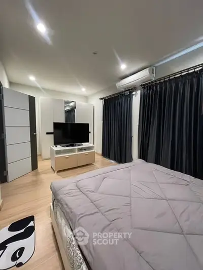 Modern bedroom with sleek design, featuring a cozy bed, stylish curtains, and a flat-screen TV for ultimate comfort.