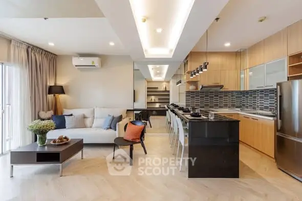 Spacious modern living room with open kitchen layout and stylish decor