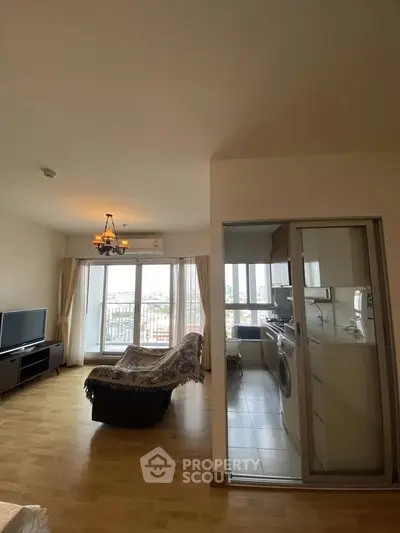 Spacious living room with balcony and adjacent kitchen in modern apartment