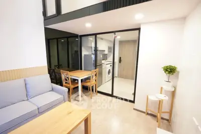 Modern living room with open kitchen and washing machine in stylish apartment