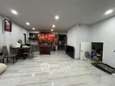 Spacious living room with modern decor and ample natural light, perfect for family gatherings.