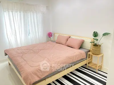 Cozy bedroom with stylish decor and natural light, featuring a comfortable bed and elegant furnishings.