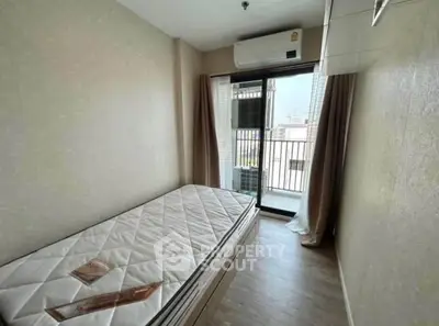 Cozy bedroom with balcony access and air conditioning in modern apartment