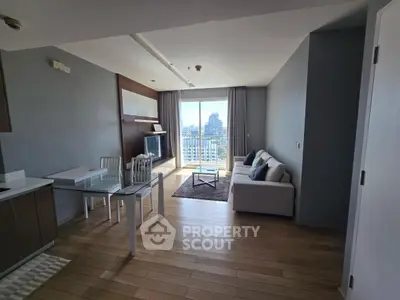 Modern living room with city view, wooden flooring, and stylish furniture