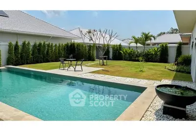 Luxurious backyard with private pool and landscaped garden in modern home.