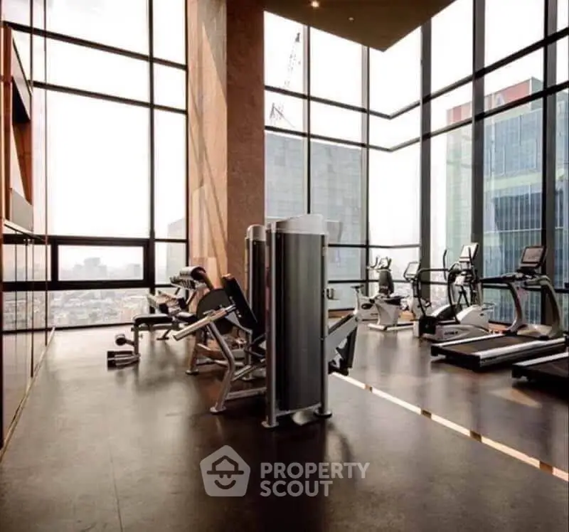 Luxurious high-rise gym with panoramic city views and modern fitness equipment.