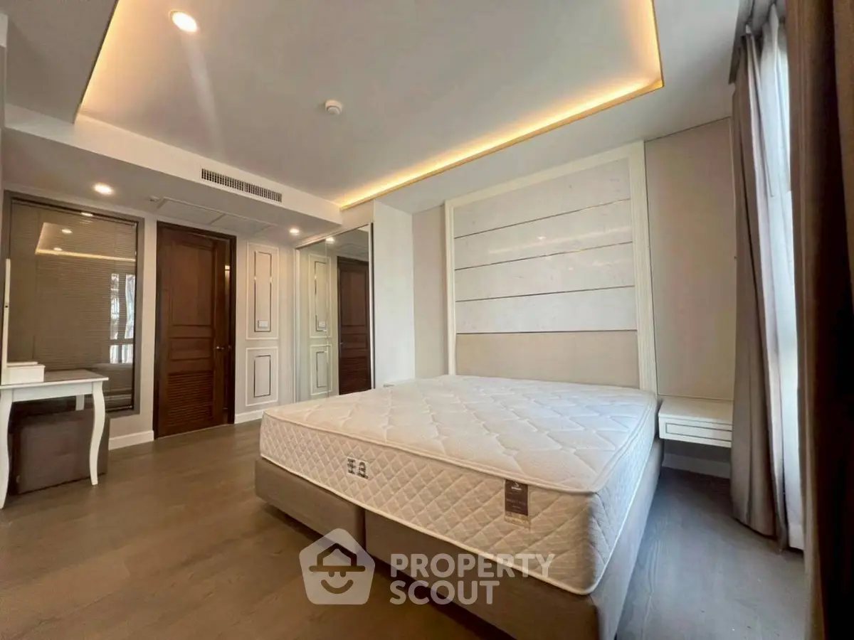 Luxurious bedroom with elegant design and ample natural light, featuring a comfortable bed and stylish decor.