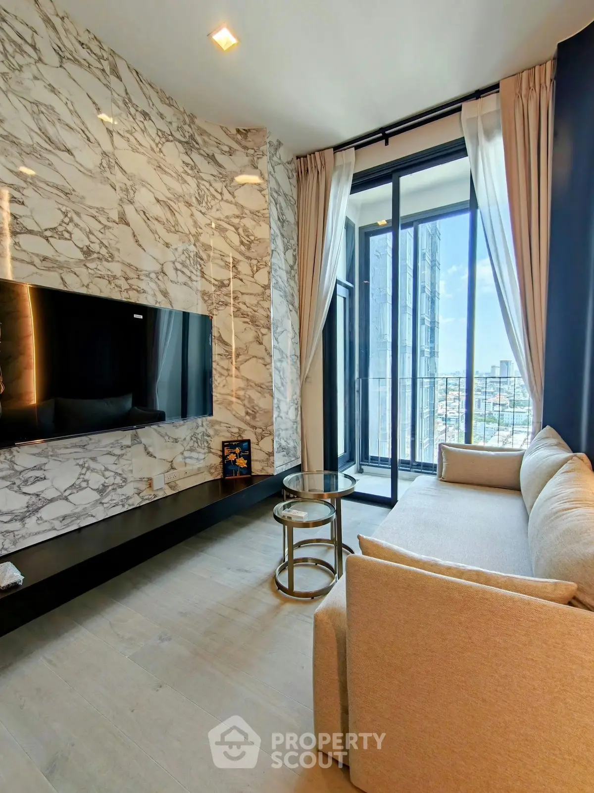 Luxurious living room with marble accent wall and city view balcony