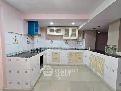 Spacious kitchen with modern appliances and ample storage space