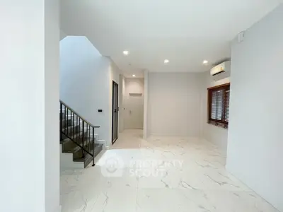 Spacious modern interior with marble flooring and staircase, ideal for stylish living.