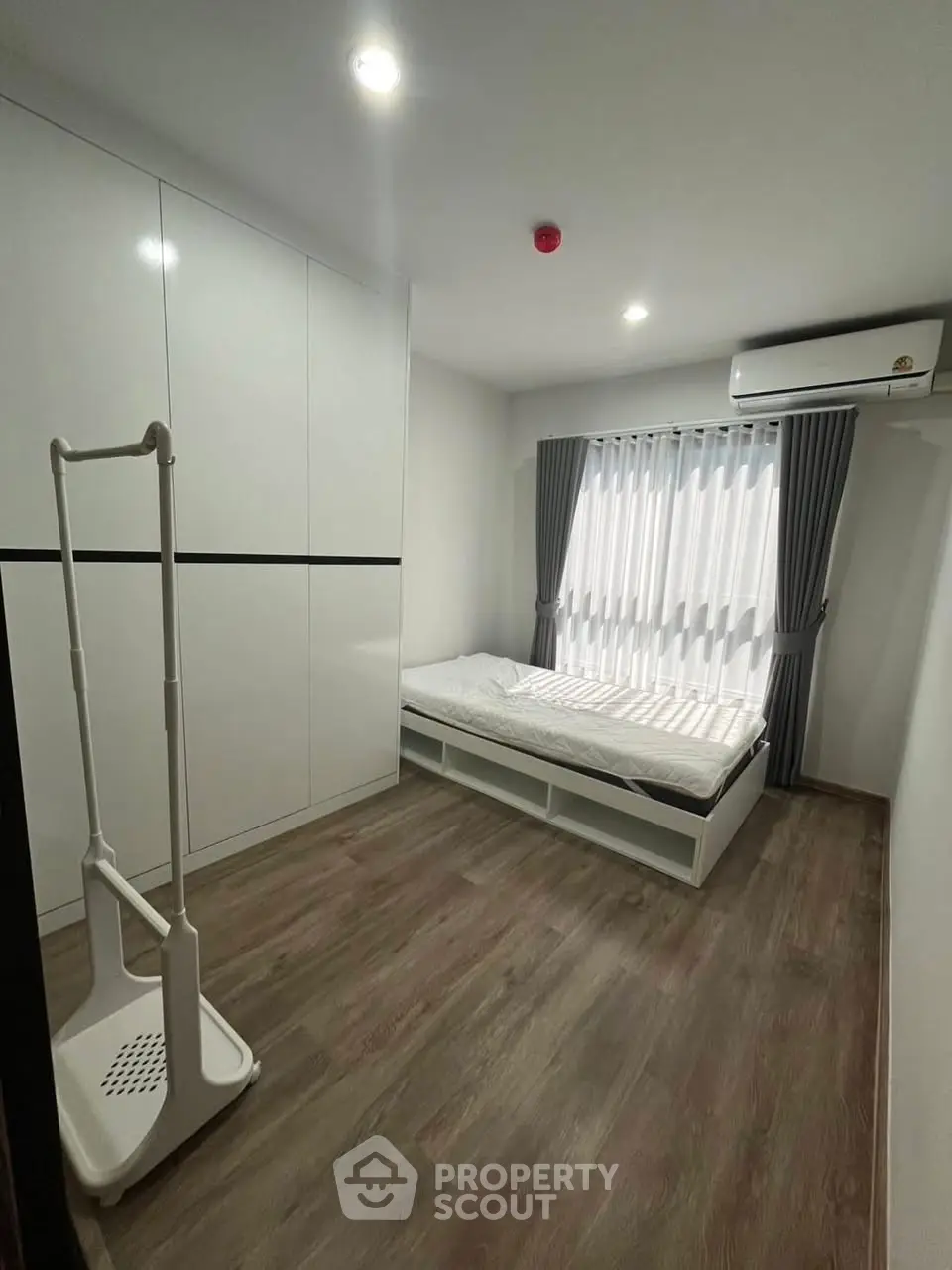 Modern minimalist bedroom with sleek design and ample storage space